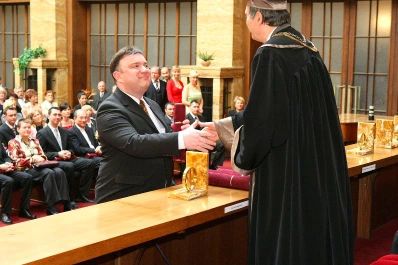 Prof. Dr. Mathias Kunze at the formal handover of his doctoral diploma by the Dean of the Faculty of Management at Comenius University in 2009. Prof. Dr. Mathias Kunze accepting his doctoral diploma in 2009.